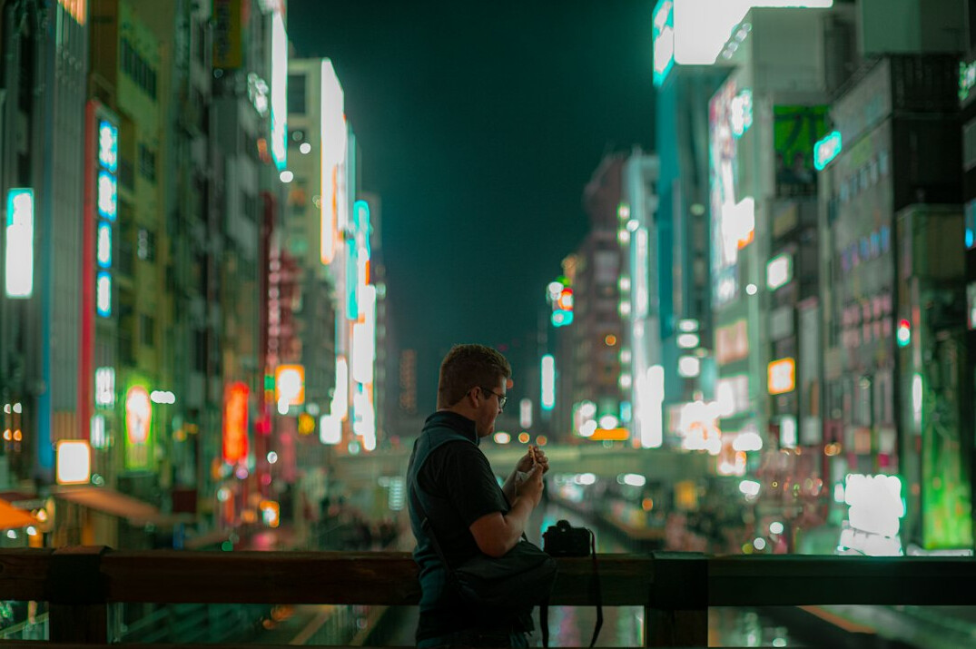 Japanese developer analyzing data on laptop